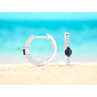 14K White Gold Huggie Earrings with Oval Sapphires and Pavé-Set Round Diamonds - 0.50 Carat Total Sapphire Weight and 0.20 Carat Total Diamond Weight - Royal Jewelry