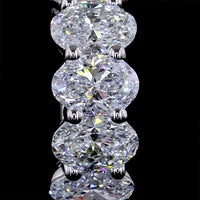 14K White Gold Oval Lab Diamond Huggie Earrings with Shared Prong Setting - 2.08 Carat Total Weight, E-F Color, VS1 Clarity - Covaloro Fine Jewelry