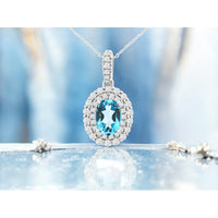 14K White Gold Pendant with Double Halo Pave-Set Diamonds and Oval Blue Topaz - 0.85 Carat Blue Topaz and 0.39 Carat Diamond Total Weight - Royal Jewelry