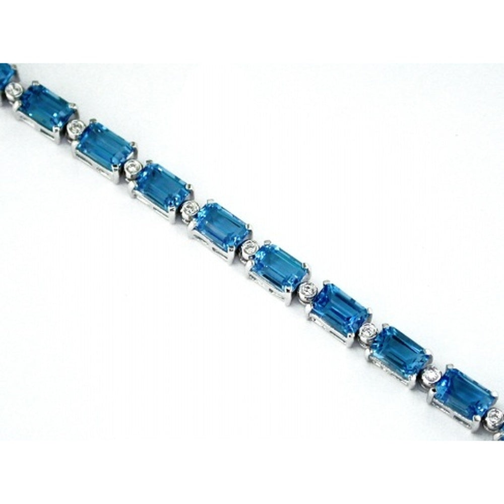 14K White Gold Tennis Bracelet with Emerald Cut Blue Topaz and Round Diamond Accents - 13.70 Carat Total Topaz Weight and 0.15 Carat Total Diamond Weight - Royal Jewelry