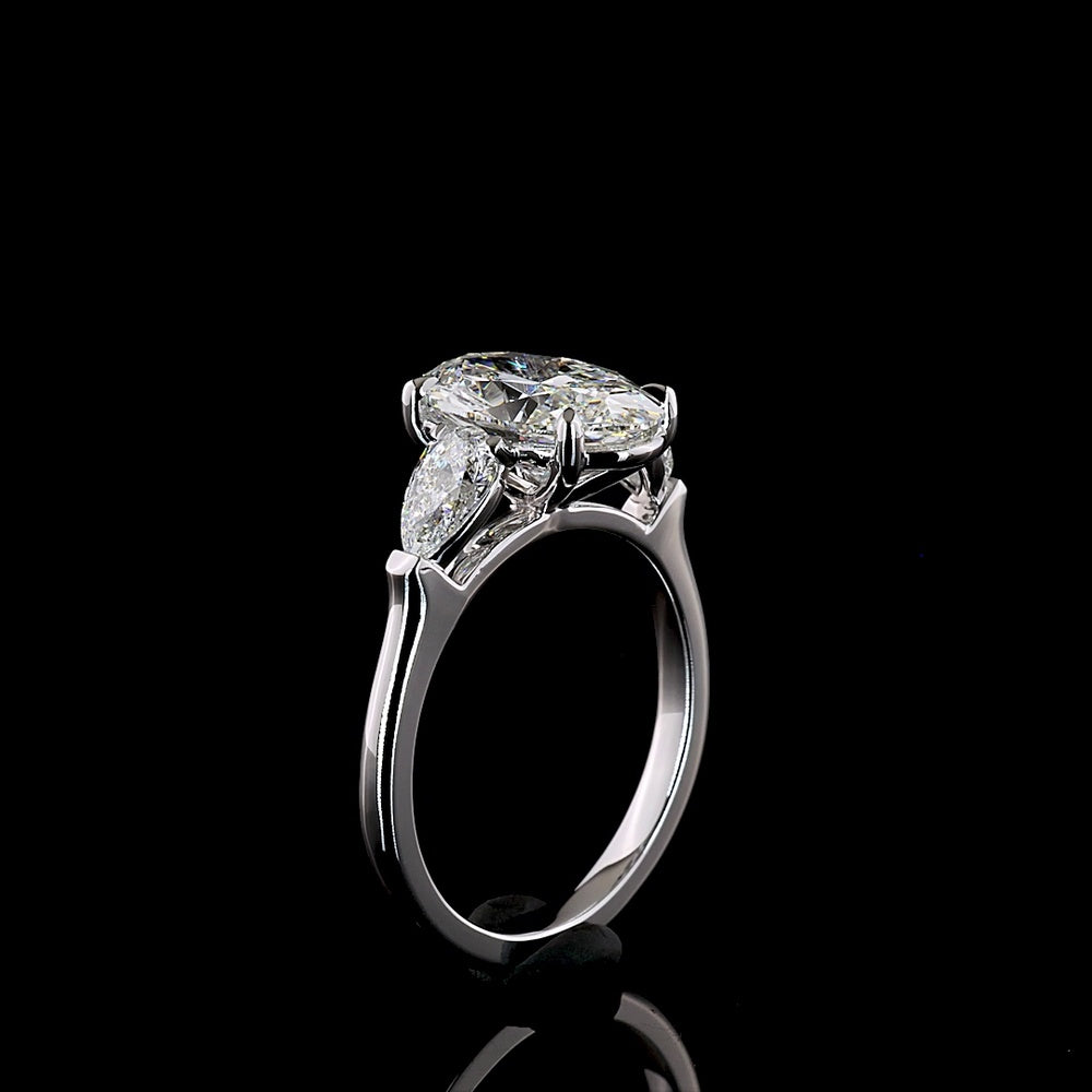 14K White Gold Three-Stone Ring with 2.69 Carat Oval Cut Lab Diamond and 0.66 Carat Pear Shaped Side Stones - IGI Certified E VVS2 - Covaloro Fine Jewelry