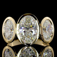 14K Yellow Gold Bezel Set Three Stone Oval Cut Lab Diamond Ring Featuring a 2.01 Carat Center Stone with E-F VVS2 Clarity - 4.07 Carats Total Diamond Weight - Covaloro Fine Jewelry