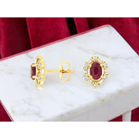 14K Yellow Gold Oval Ruby and Diamond Halo Stud Earrings with Alternating Round and Baguette Accents - 1.20 Carat Total Ruby Weight and 0.32 Carat Total Diamond Weight - Royal Jewelry