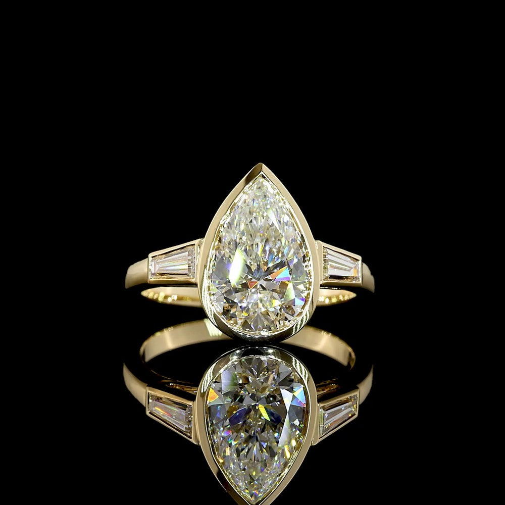 14K Yellow Gold Pear Shape Three Stone Ring with Bezel Set 2.52 Carat Lab Diamond and Tapered Baguette Side Stones - 2.93 Carat Total Diamond Weight - Covaloro Fine Jewelry