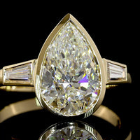 14K Yellow Gold Pear Shape Three Stone Ring with Bezel Set 2.52 Carat Lab Diamond and Tapered Baguette Side Stones - 2.93 Carat Total Diamond Weight - Covaloro Fine Jewelry