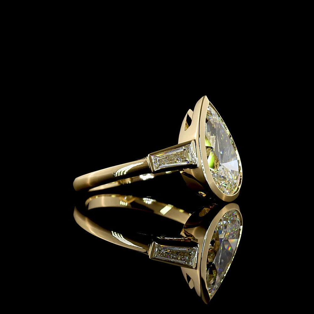14K Yellow Gold Pear-Shaped Three-Stone Ring with Bezel-Set 3.50 Carat Lab Diamond and Tapered Baguettes - 4.00 Carat Total Weight - Covaloro Fine Jewelry