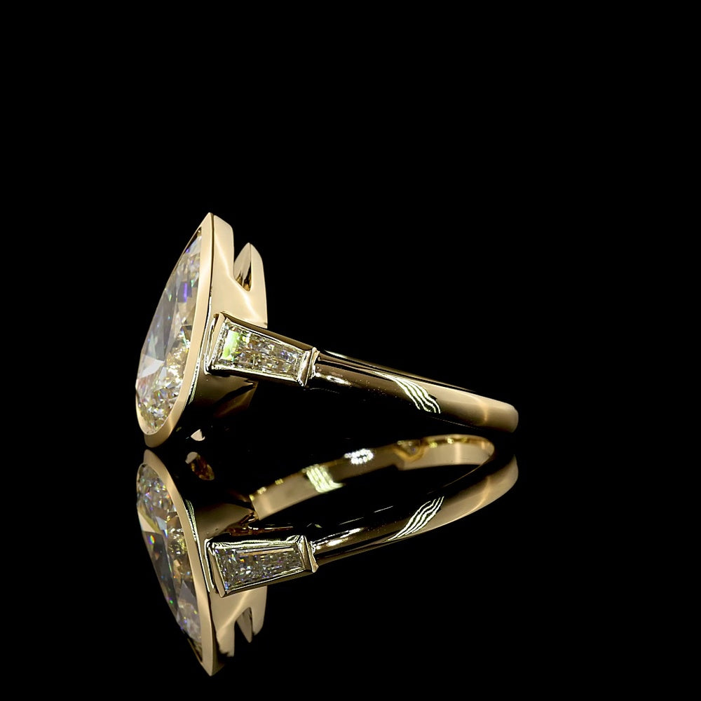 14K Yellow Gold Pear-Shaped Three-Stone Ring with Bezel-Set 3.50 Carat Lab Diamond and Tapered Baguettes - 4.00 Carat Total Weight - Covaloro Fine Jewelry