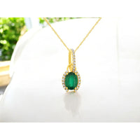 14K Yellow Gold Pendant Necklace with Oval Emerald and Pavé Diamond Halo and Bale - 0.75 Carat Emerald and 0.10 Carat Total Diamond Weight - Royal Jewelry