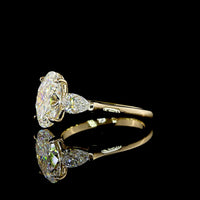 14K Yellow Gold Three Stone Ring with 2.20 Carat Oval Cut Lab Diamond and 0.60 Carat Pear Cut Lab Diamonds - 2.80 Carat Total Weight - Covaloro Fine Jewelry