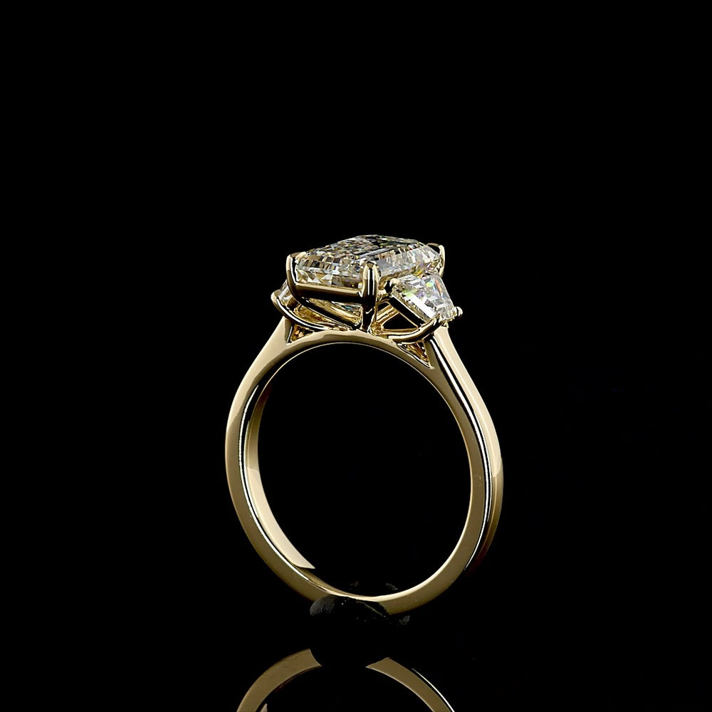 14K Yellow Gold Three Stone Ring with 2.69 Carat Emerald Cut Lab Diamond and 0.79 Carat Trapezoid Side Stones - 3.48 Carat Total Diamond Weight - Covaloro Fine Jewelry