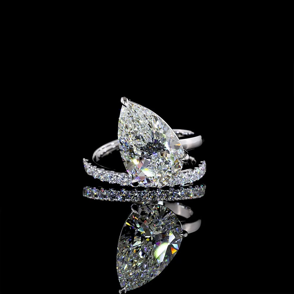 18K White Gold Pear Shape Solitaire Diamond Shank Ring with Inclined Center and Accent Stones - 5.49 Carats Total Diamond Weight (5.04 Carats Center F VS1, 0.45 Carats Side E VS1) - Covaloro Fine Jewelry