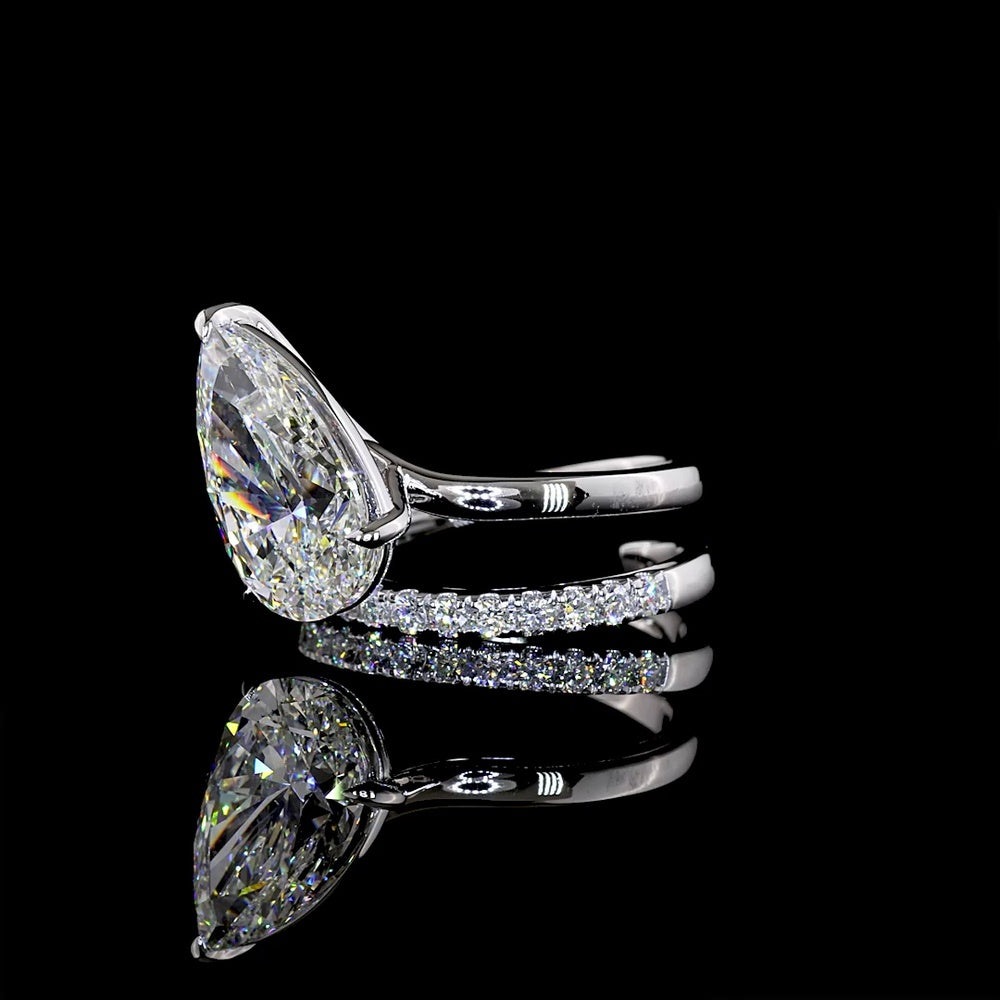 18K White Gold Pear Shape Solitaire Diamond Shank Ring with Inclined Center and Accent Stones - 5.49 Carats Total Diamond Weight (5.04 Carats Center F VS1, 0.45 Carats Side E VS1) - Covaloro Fine Jewelry