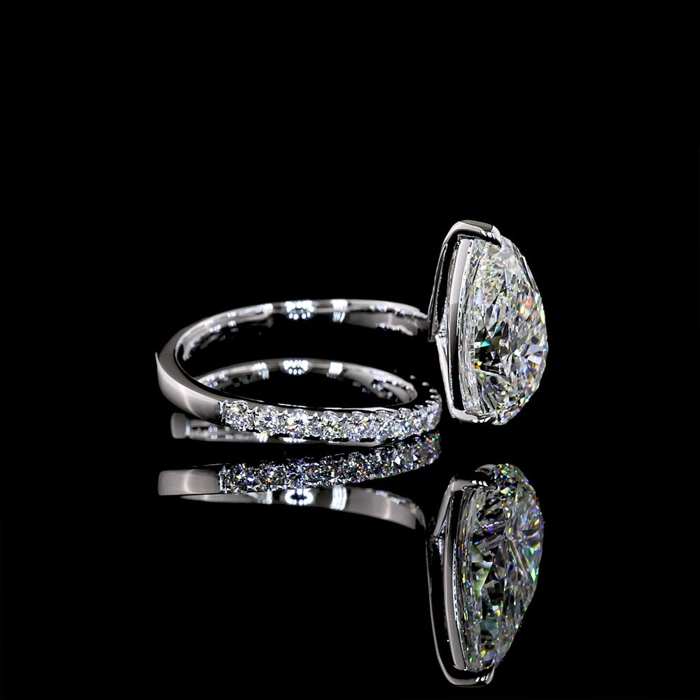 18K White Gold Pear Shape Solitaire Diamond Shank Ring with Inclined Center and Accent Stones - 5.49 Carats Total Diamond Weight (5.04 Carats Center F VS1, 0.45 Carats Side E VS1) - Covaloro Fine Jewelry