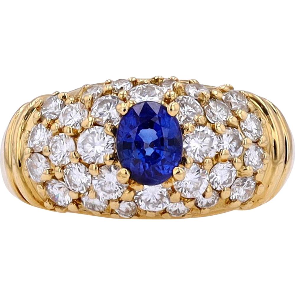 18K Yellow Gold Ring with 0.60 Carat Oval Sapphire Center and 0.95 Carat Round Diamond Cluster
