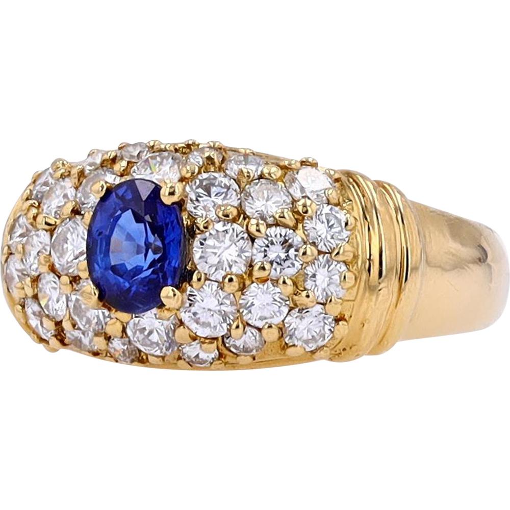 18K Yellow Gold Ring with 0.60 Carat Oval Sapphire Center and 0.95 Carat Round Diamond Cluster