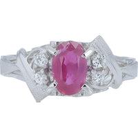 Platinum 0.72 Carat Oval Ruby Ring with 0.05 Carat Round Diamond Accents and Textured Sculptural Band