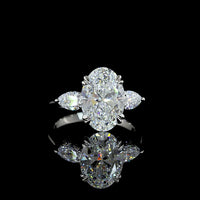Platinum 3-Stone Ring with 3.50 Carats Oval Cut Lab Diamond and Pear Shape Side Stones - 4.24 Carats Total Diamond Weight - Covaloro Fine Jewelry