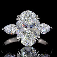 Platinum 3-Stone Ring with 3.50 Carats Oval Cut Lab Diamond and Pear Shape Side Stones - 4.24 Carats Total Diamond Weight - Covaloro Fine Jewelry