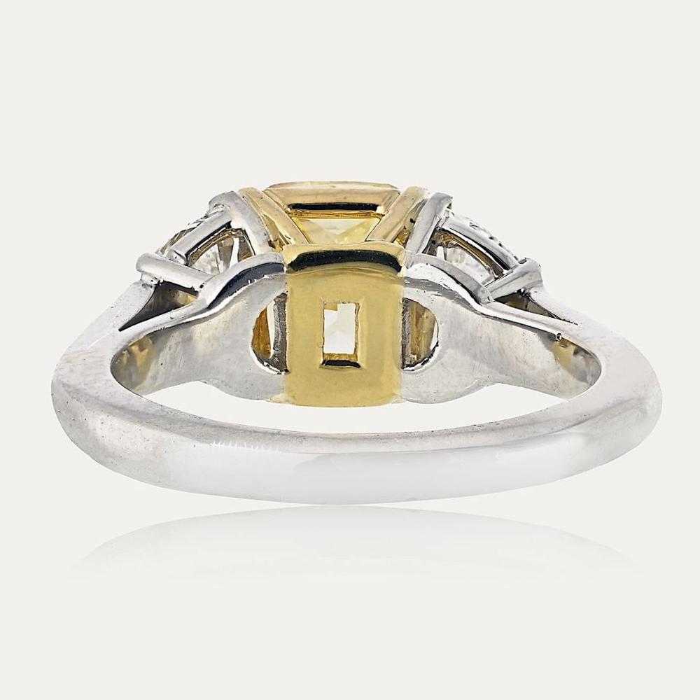 Platinum and 18K Yellow Gold 3-Stone Ring with 2.16 Carats GIA Certified Fancy Intense Yellow Radiant Cut Diamond and Diamond Shields - 0.97 Carats Total Diamond Weight