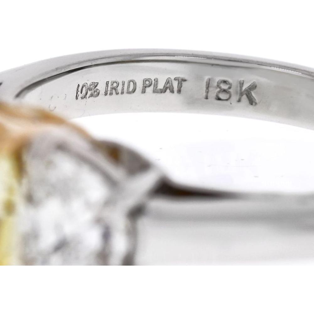Platinum and 18K Yellow Gold 3-Stone Ring with 2.16 Carats GIA Certified Fancy Intense Yellow Radiant Cut Diamond and Diamond Shields - 0.97 Carats Total Diamond Weight