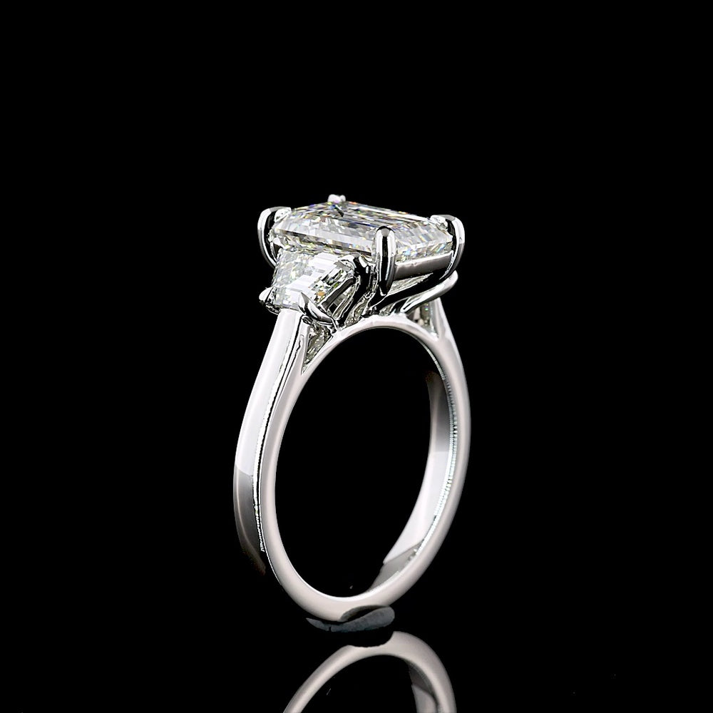 Platinum Three Stone Ring with 3.18 Carat Emerald Cut Lab Diamond and 1.07 Carat Trapezoid Cut Lab Diamonds - 4.25 Carat Total Weight - Covaloro Fine Jewelry