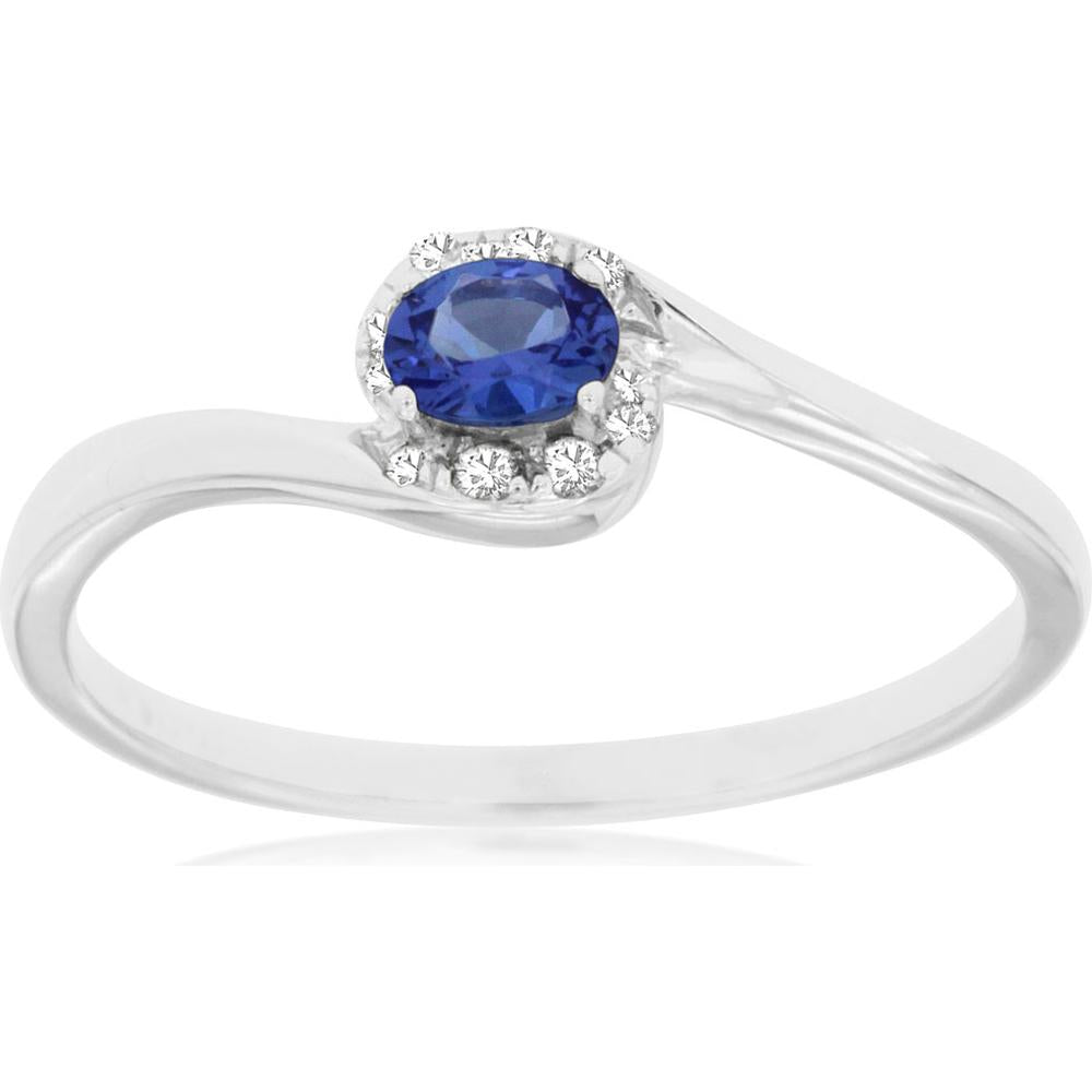 Royal 14K White Gold Halo Ring with Oval Tanzanite and Round Diamonds - 0.16 Carat Tanzanite and 0.06 Carat Total Diamond Weight