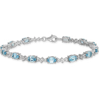 Sterling Silver Rhodium-Plated Tennis Bracelet with Oval Swiss Blue Topaz & Round White Topaz - 0.61 Carat Total Gem Weight by Monteluci Fine Jewelry