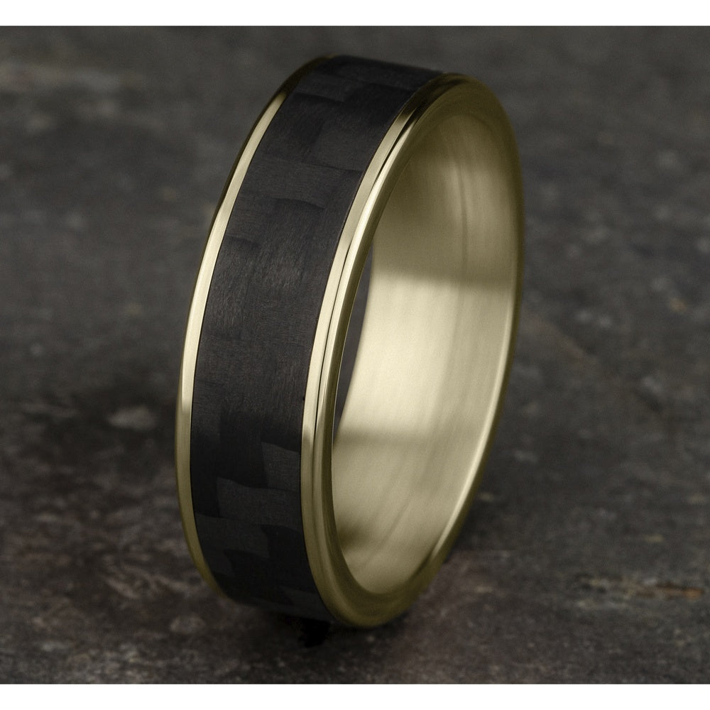 The Schumacher Men's Wedding Band in 14K Yellow Gold and Black Carbon Fiber - 6.5mm Width by Ammara Stone
