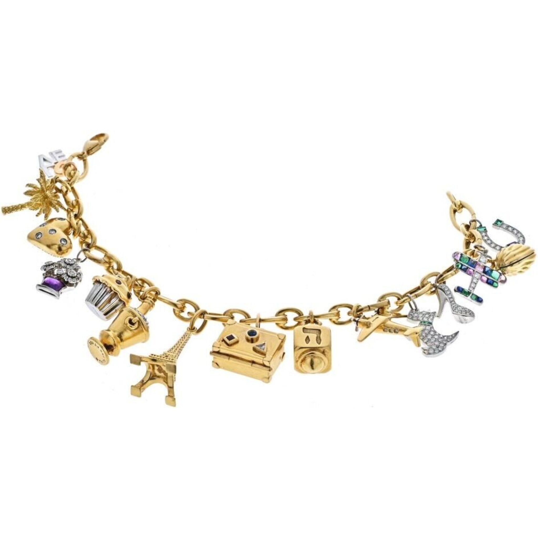 Gold charm bracelet with platinum trinkets 